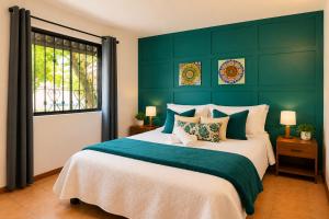 a bedroom with a large bed with a green wall at Morada Luna Coyoacán in Mexico City
