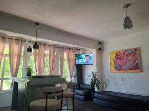 a living room with a couch and a tv at Casa Madre Kravice Waterfalls in Ljubuški