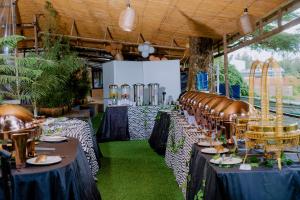a banquet hall with tables and chairs and green grass at Nature Kigali in Kigali