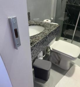 a bathroom with a sink and a toilet at Rafa Plaza Hotel in Cassilândia