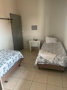 a small bedroom with a bed and a table at Rafa Plaza Hotel in Cassilândia +21 photos