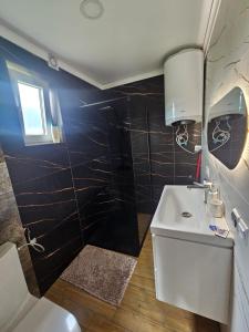 a bathroom with a white sink and a shower at Przystań Vianneya in Giebułtów +3 photos