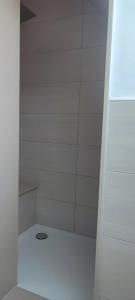 a bathroom with a white shower with a drain at Villa Residenz am Vulkanradweg in Grebenhain