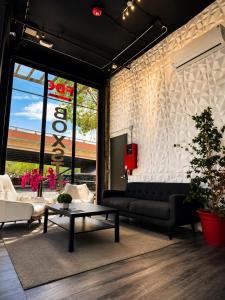 a living room with a couch and a table at Boxstel - Modern Stay Hotel Downtown El Paso in El Paso