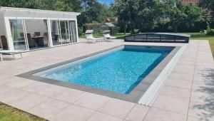 a swimming pool in a yard with a patio at Comwell in Odense