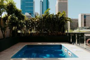 a swimming pool with a city skyline in the background at InterContinental Brisbane by IHG in Brisbane +100 photos