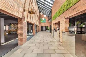 a brick building with a walkway in the middle at Comwell in Odense