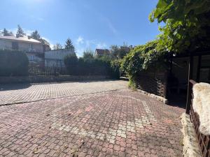 a brick driveway in front of a house at Studio Tatarskie,Parking! in Przemyśl