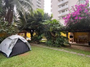 a tent sitting on the grass in a yard at Pousada Hostel Brazil Backpackers in Guarujá