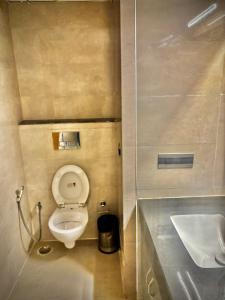 a small bathroom with a toilet and a sink at The Novaire in Lucknow +7 photos