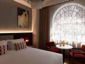 a bedroom with a bed and a table and a window at Hotel Morris Sydney, Handwritten Collection in Sydney +75 photos