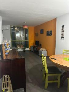 a living room with a table and yellow walls at Un lugar cerca de todo in Buenos Aires +14 photos