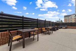a row of tables and chairs on a roof at Drury Plaza Hotel Mobile in Mobile