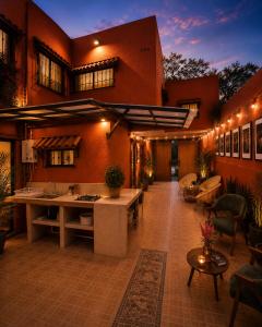 an outdoor patio with tables and chairs and a building at Morada Luna Coyoacán in Mexico City