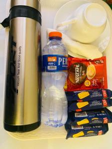 a bottle of water and other items in a refrigerator at Texas Royal Hotel in Pokuase