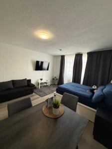 a living room with a bed and a couch at Modern Apartment Close to Bus Station in Würzburg
