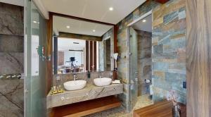 a bathroom with two sinks and a large mirror at Bliss Properties Jacuzzi Suite Free Pool Access in Draç +2 photos