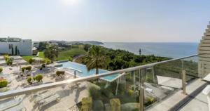 a balcony with a view of a pool and the ocean at Bliss Properties Jacuzzi Suite Free Pool Access in Draç