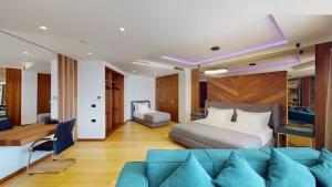 a hotel room with a bed and a couch at Bliss Properties Jacuzzi Suite Free Pool Access in Draç