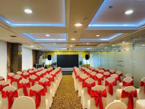 a banquet hall with red and white chairs and a stage at Happy Life Hotel District 7 Gần SECC in Ho Chi Minh City