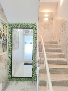 a staircase with a mirror and marble walls at Hotel Solferino in Brescia