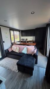a living room with a couch and a table at Frogs Hollow in Greytown