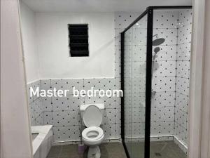 a bathroom with a toilet and a sink and a shower at NiNo in Vaitele +5 photos