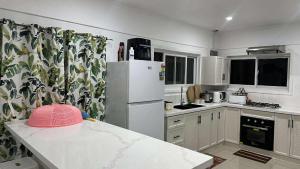 a kitchen with a refrigerator and a counter top at NiNo in Vaitele