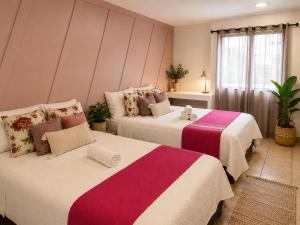 two beds in a hotel room with two at Morada Luna Coyoacán in Mexico City +64 photos