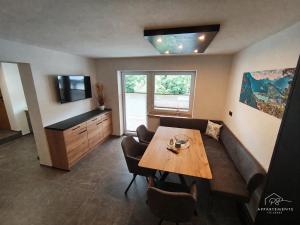 a living room with a table and a couch at PS-Apartment Luis in Vorderthiersee