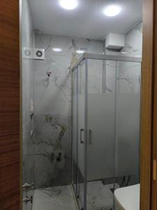 a shower with a glass door in a bathroom at Vizyon Konak in Burhaniye +10 photos