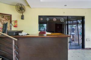 a kitchen with a bar with a mirror on the wall at Hotel O Pariwar Inn in Hyderabad