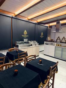 a restaurant with two tables and a kitchen at B&B Valhalla in Paola