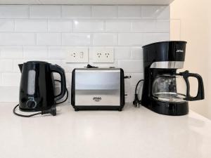 two coffeemakers sitting on a counter next to a toaster at Dolce Apartment in Buenos Aires