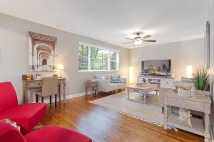 a living room with a red couch and a table at Chicago Charm in Chicago
