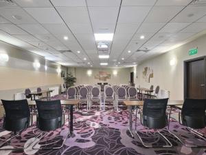 a conference room with tables and chairs on a carpet at Handwritten Collection-Bucharest Unirii Square in Bucharest