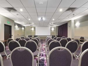 a conference room with chairs and a projection screen at Handwritten Collection-Bucharest Unirii Square in Bucharest