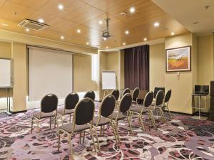 a conference room with chairs and a white screen at Handwritten Collection-Bucharest Unirii Square in Bucharest