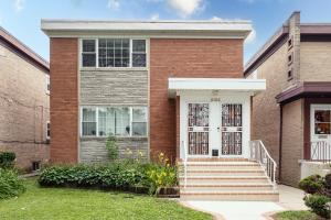 a brick house with a white door at Chicago Charm in Chicago