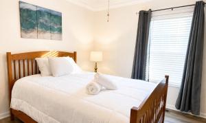 a bedroom with a large white bed with a window at Beautiful, Cozy home in Concord in Concord
