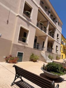 a bench sitting in front of a building at Maison Madeleine in La Maddalena