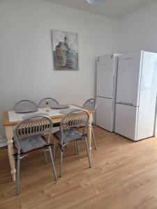 a kitchen with a table and a white refrigerator at High Tide House in Waterford