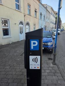 a parking meter on the side of a street at High Tide House in Waterford