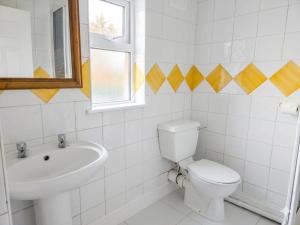 a white bathroom with a toilet and a sink at High Tide House in Waterford +47 photos