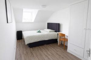 a bedroom with a bed and a table and a chair at High Tide House in Waterford