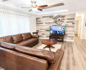 a living room with a leather couch and a television at Beautiful, Cozy home in Concord in Concord