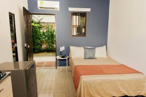 a small bedroom with a bed and a small table at Poblado-Aguacatala Apart-Hotel in Envigado
