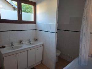 a bathroom with a sink and a toilet and a window at Gîtes proche lac de chalain in Montigny-sur-lʼAin +21 photos