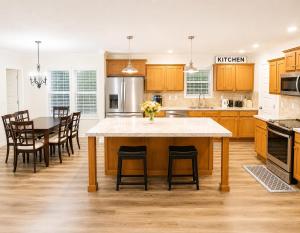a kitchen with a large island with chairs and a table at Beautiful, Cozy home in Concord in Concord