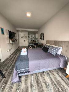a bedroom with a large bed and a living room at @juanbjustoapartamento in Buenos Aires